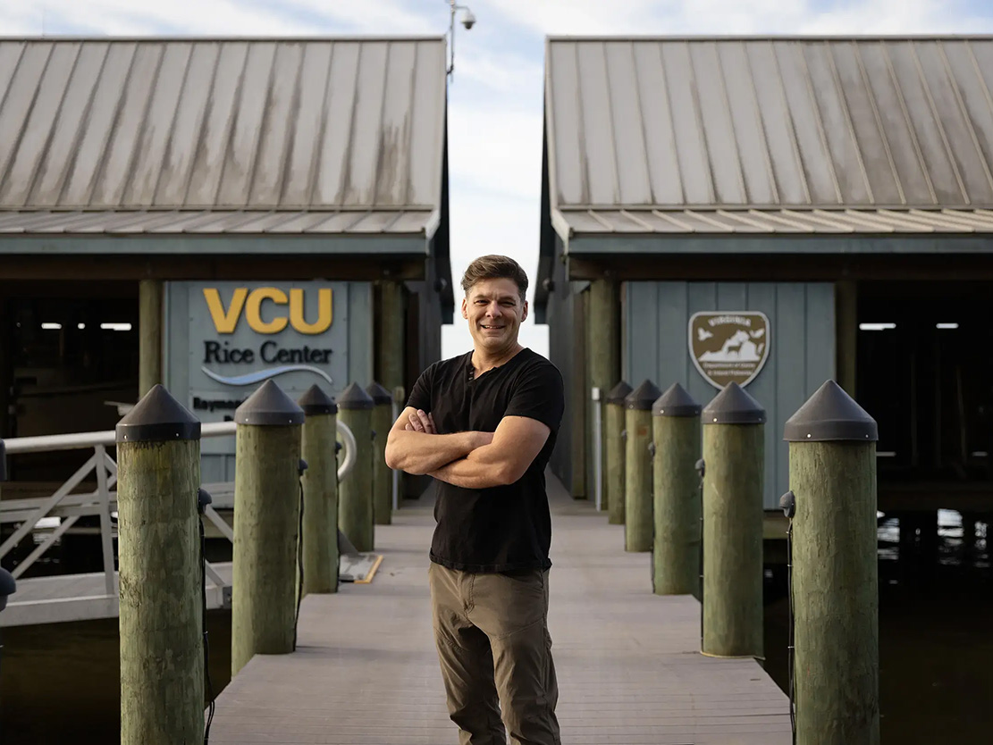 Chris Gough stands on a dock at the Rice Rivers Center